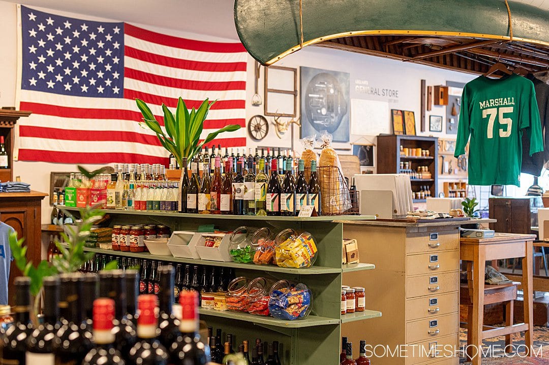 Image of an American flag, an upside down canoe hanging from the ceiling and products at LeClair's general store.