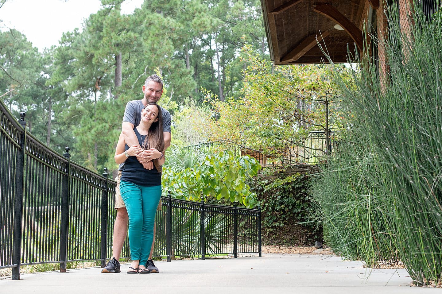 A couple embracing at Cape Fear Botanical Garden in Fayetteville, NC