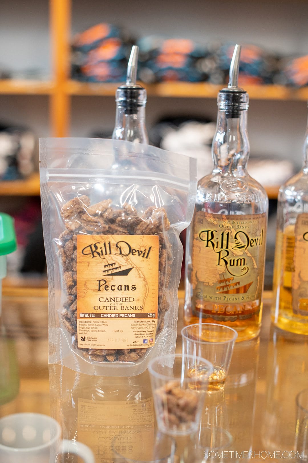 A bag of candied pecans next to a bottle of rum at Outer Banks Distilling in North Carolina.