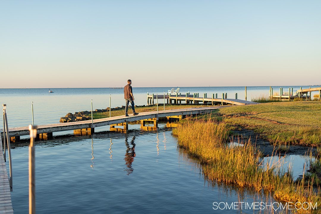 October in the Outer Banks in NC, with a man walking on a dock on the Inn on Pamlico Sound.