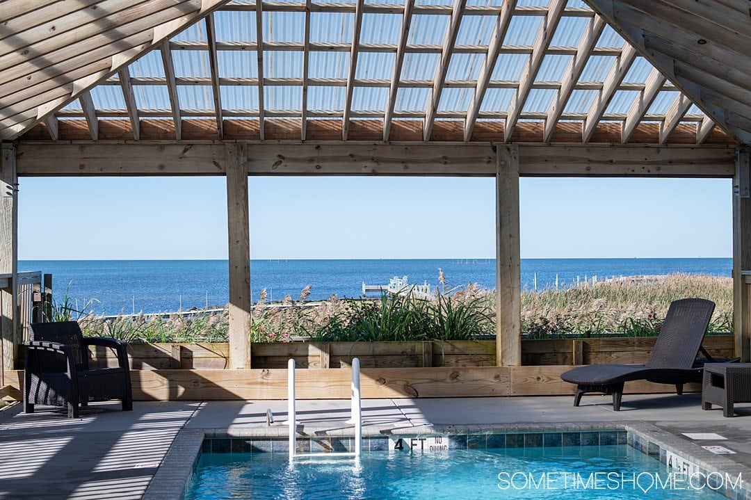 Pool inside a wooden structure with a view out to the sound at the Inn on Pamlico Sound.