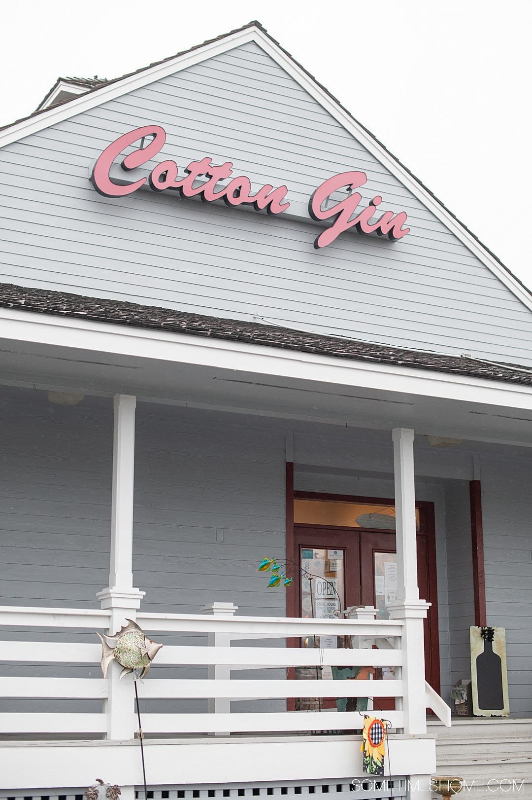 Grey building in the Outer Banks that says Cotton Gin in red letters.