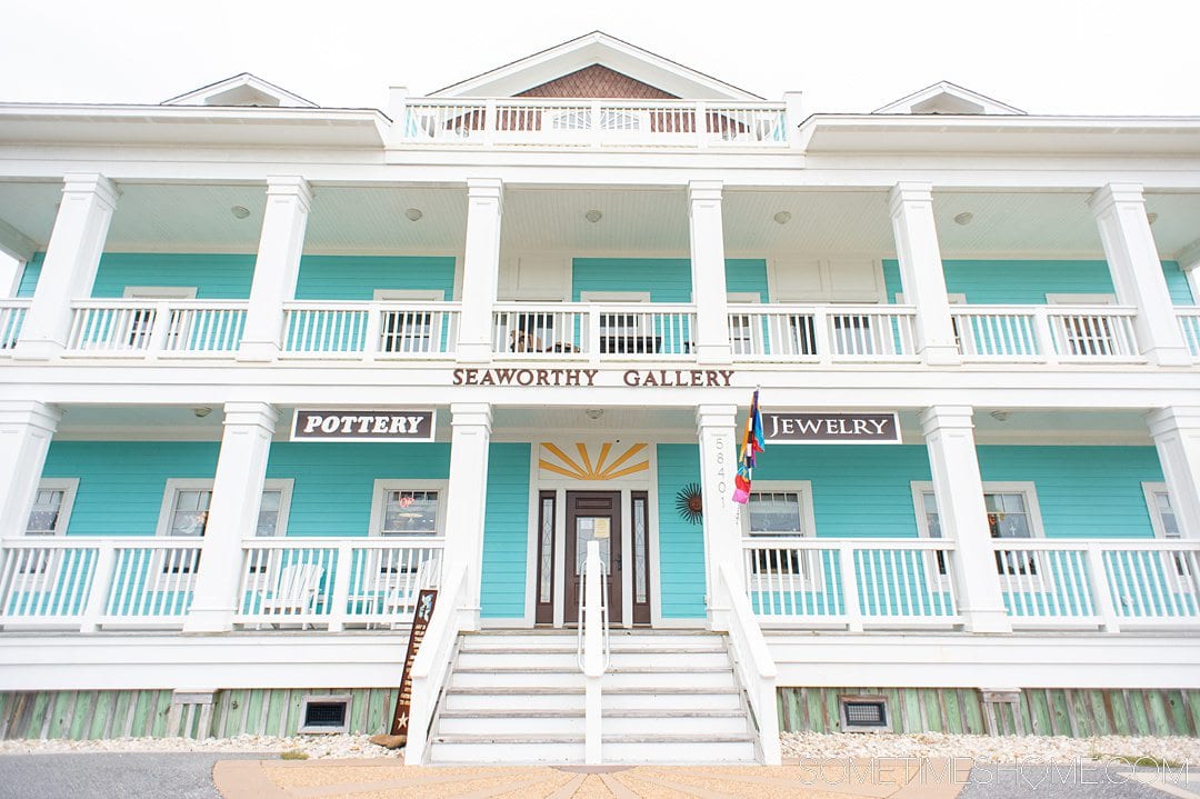 Blue and white art gallery building in the Outer Banks that reads "Seaworthy Gallery" on the outside.