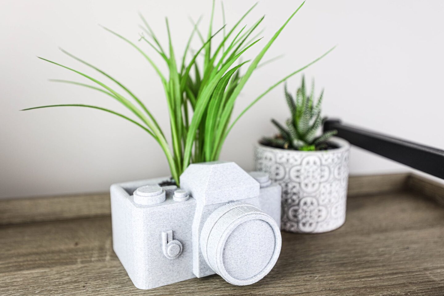 Small camera planter in granite style material from Etsy.