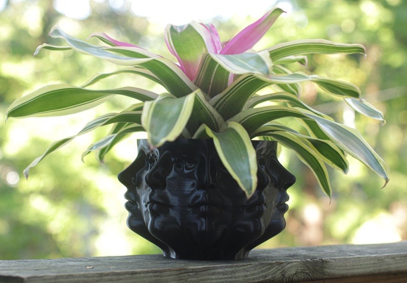 Black planter with multiple molded faces for unique house warming gift ideas.