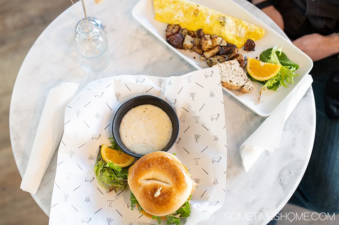 Bagel and grits and omelet with potatoes and an orange wedge at The Table in Asheboro, NC.