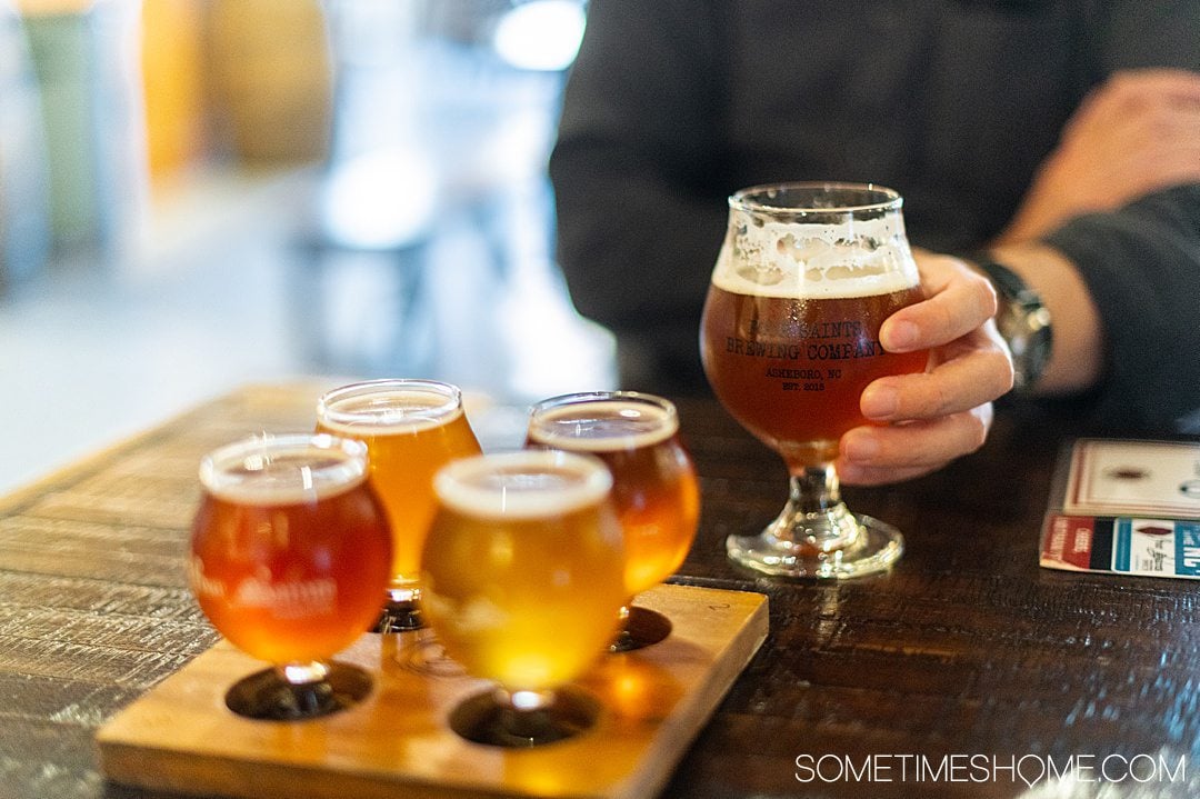 Flight of beer and a pint at Four Saints Brewing Company in Asheboro, NC.