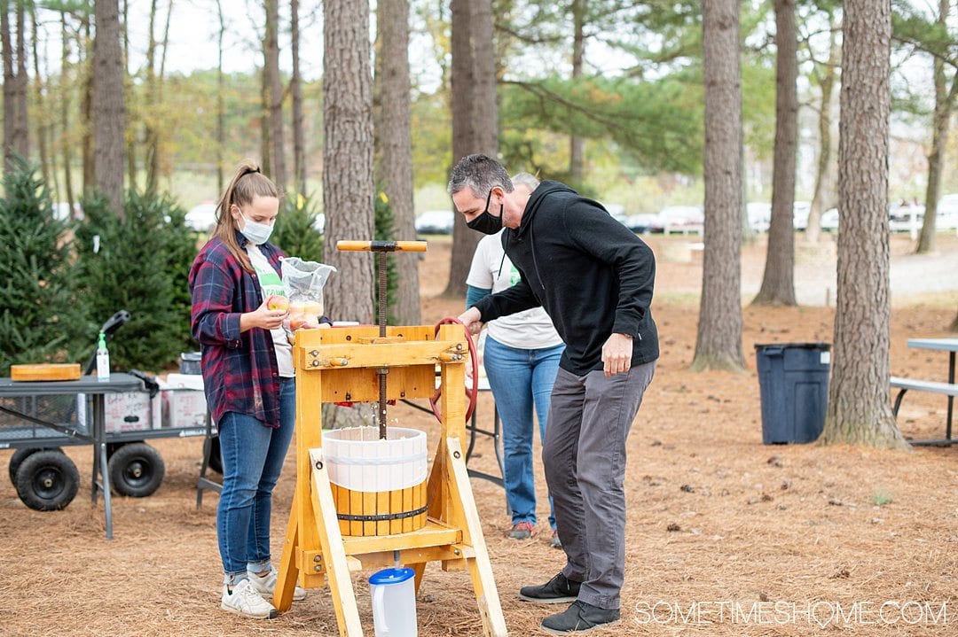 A man and woman making apple cider at Millstone Creek Orchards in North Carolina.