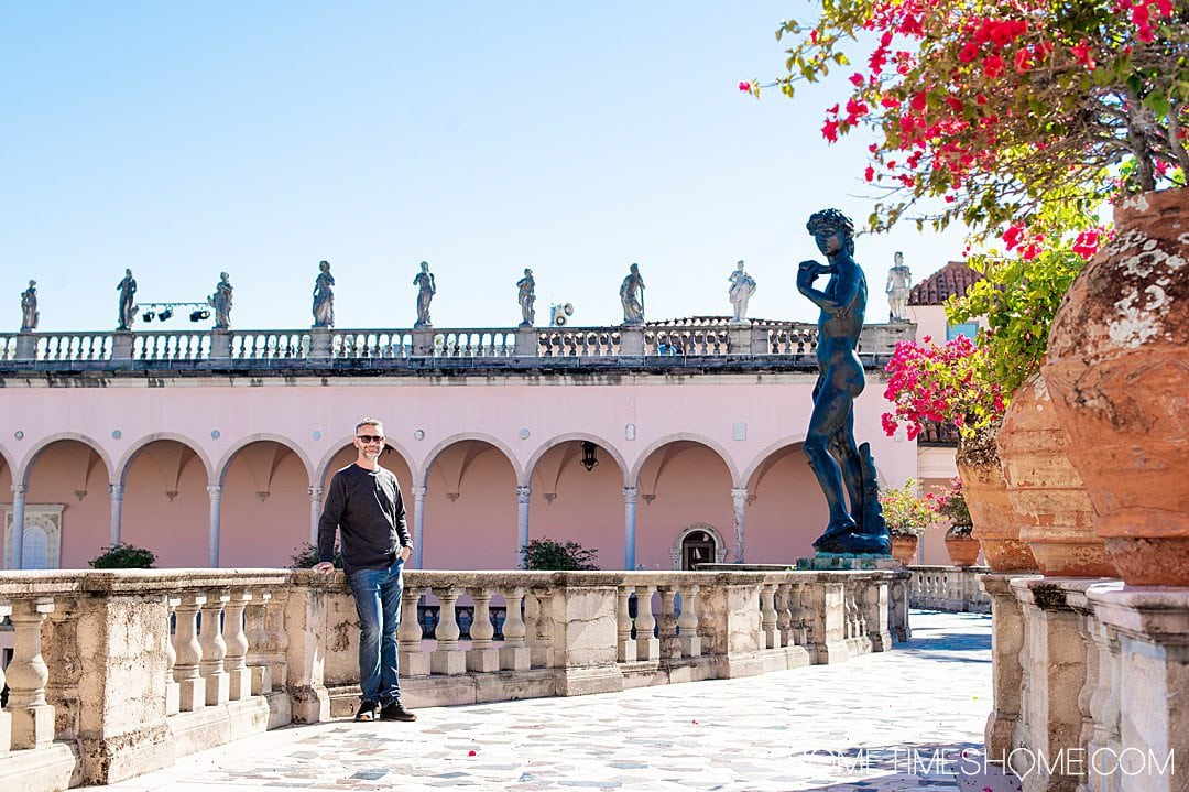 Interior courtyard and pink colonnade the art museum at The Ringling in Sarasota, FL with a man on the left.