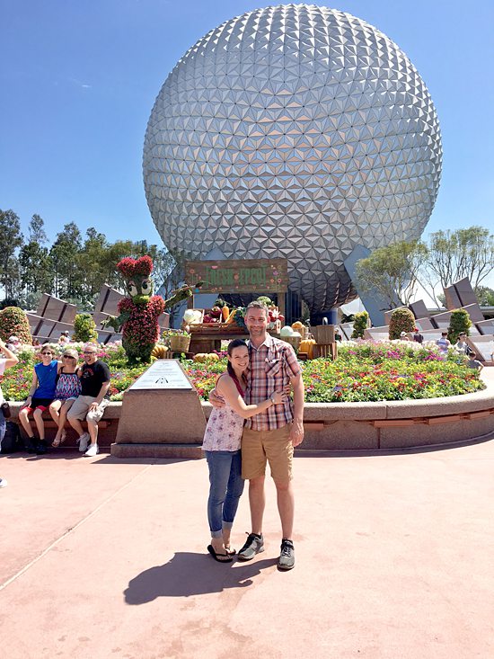 Couple in front of Epcot Spaceship Earth.