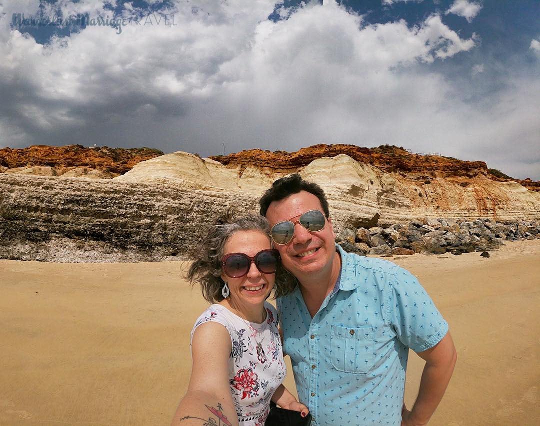 Couple in front of a plateau and blue sky. 