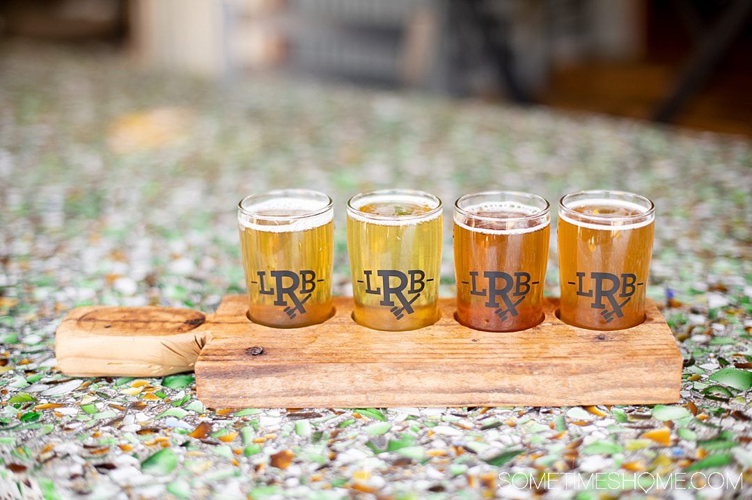 A wood board with four sample beer pours in a beer flight at Legal Remedy Brewing in Rock Hill, South Carolina.