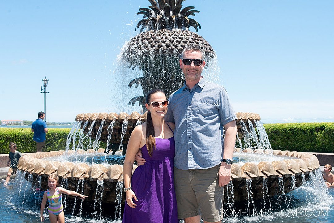 Couple in front of a pineapple fountain in downtown Charleston, which is great for photos.