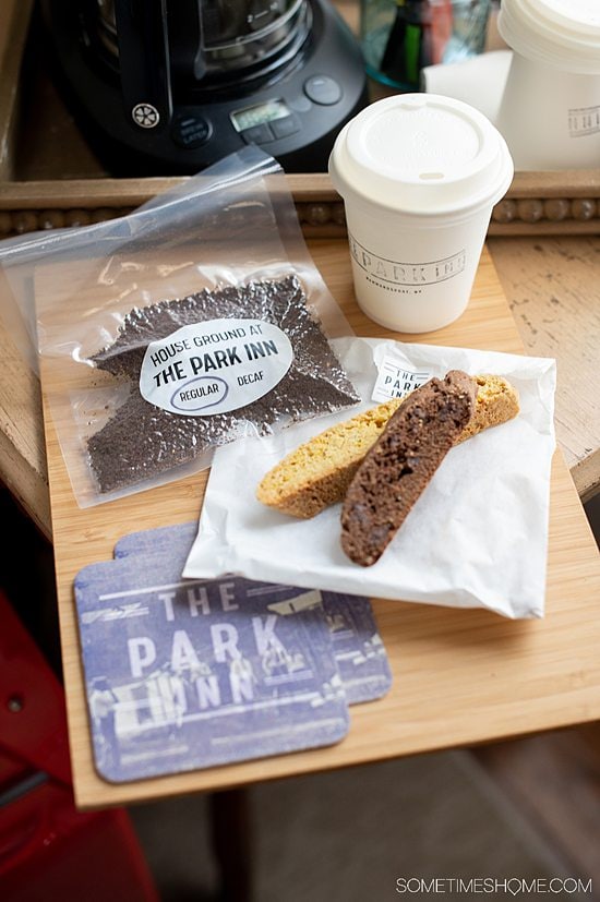 Biscotti, coffee grinds in a bag and a coffee cup on a table at The Park Inn.