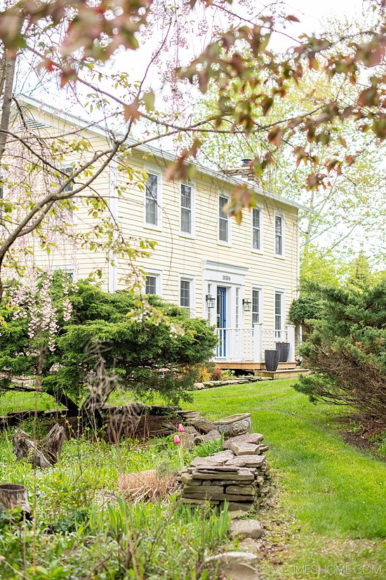 Pale yellow exterior of a rental home, Glenn Scott Manor, in Hammondsport, NY in the Finger Lakes.