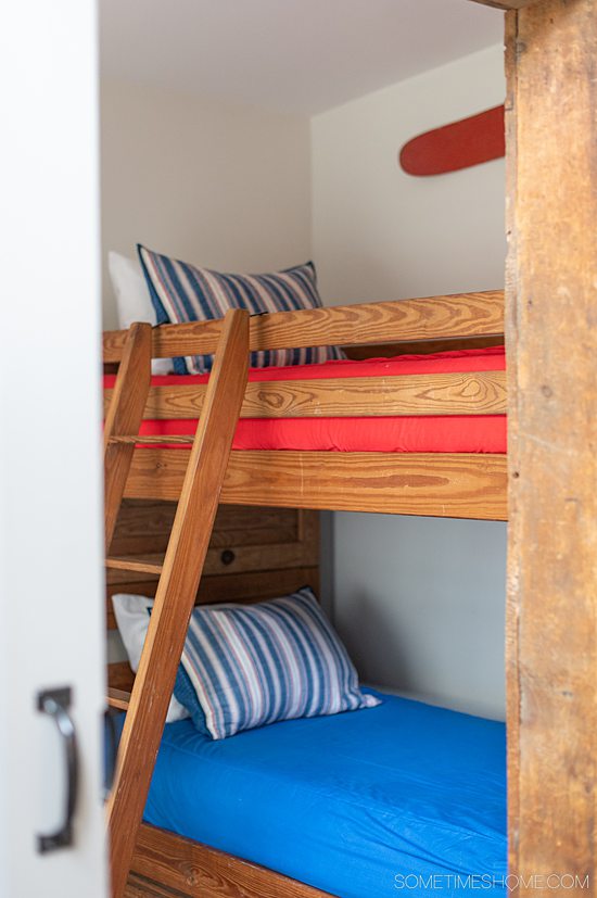 Red, blue and white wooden bunk beds at Glenn Scott Manor in Hammondsport, NY.