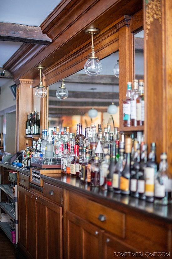 Bottles behind a bar with a mirror behind them at The Park Inn restaurant, in Hammondsport, NY.