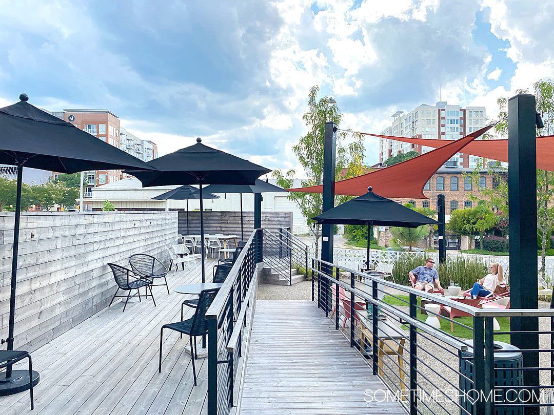 Outdoor seating area on a deck at the Longleaf Hotel in downtown Raleigh