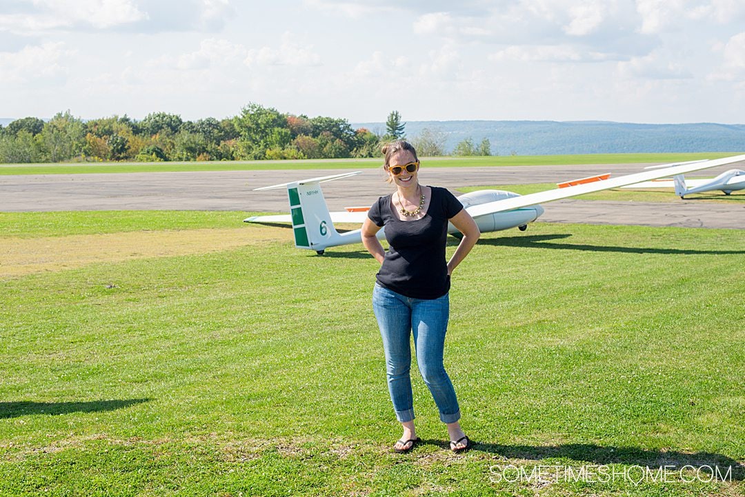 Woman in front of a glider plane in the Finger Lakes of New York.