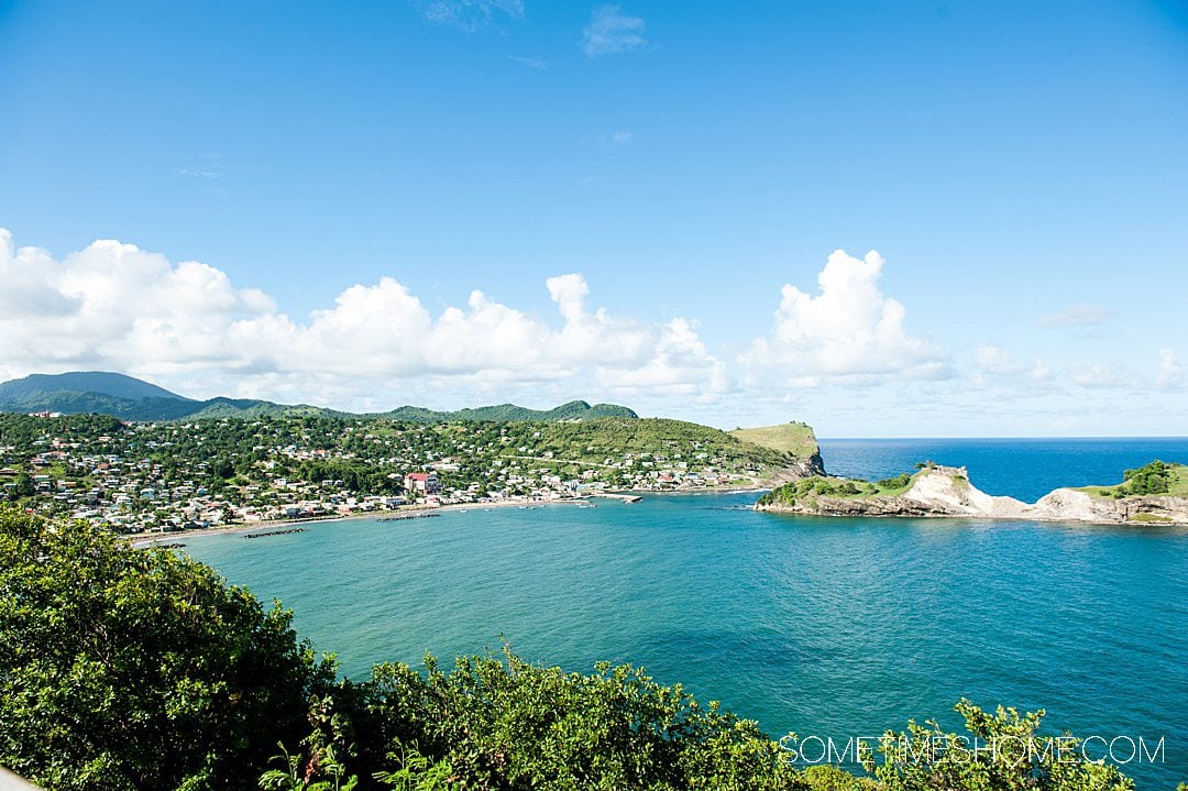 Looking down onto a bay in St. Lucia seen from an elevation, with turquoise blue Caribbean water.