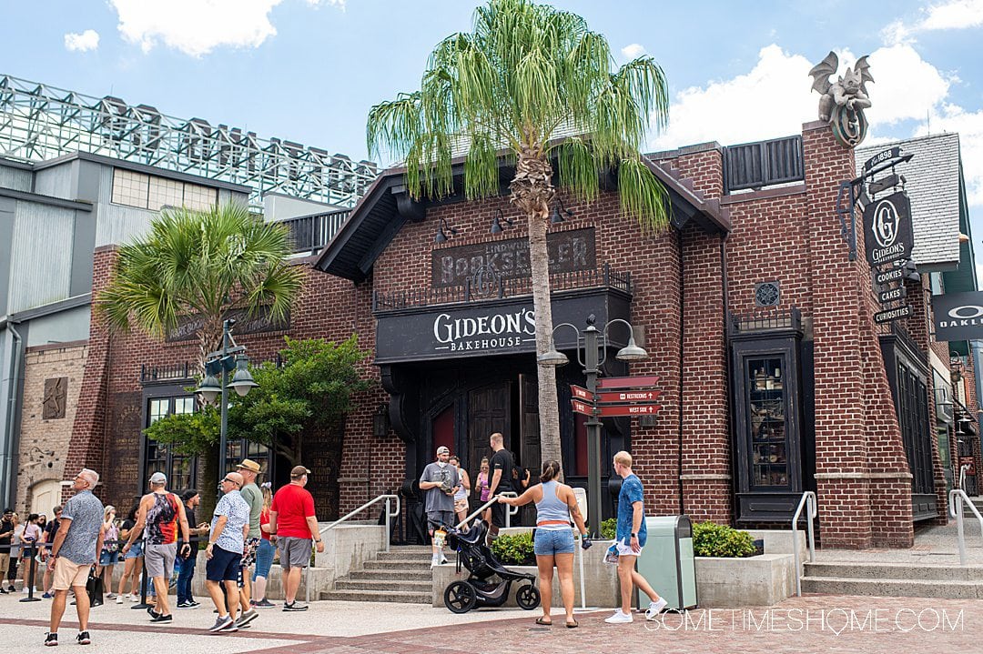 Brick storefront at Disney Springs for Gideon's Bakehouse desserts with people in front of the shop.