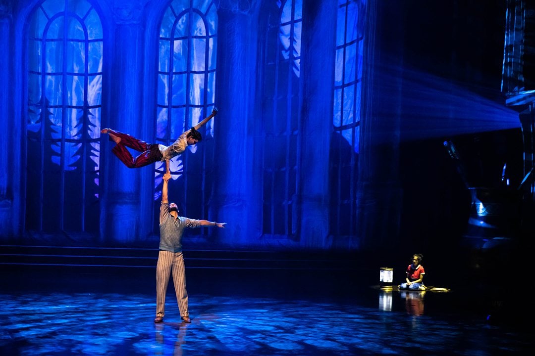 Couple performs acrobatics during a romantic scene of Cirque du Soleil Drawn to Life at Disney Springs.