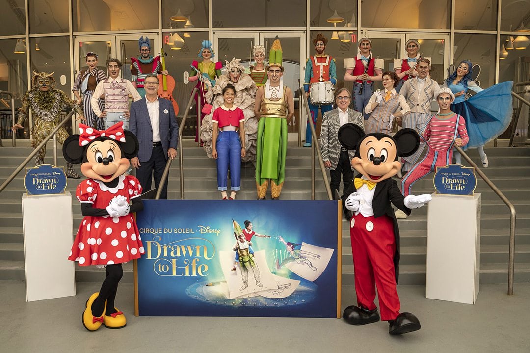 Premiere photo of Cirque du Soleil Drawn to Life on the steps of the theater at Disney Springs.