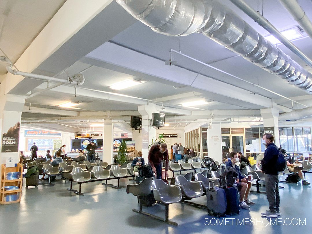 Interior of the Catalina Island Express ferry terminal at Long Beach, California. Grey seats line an inside seating area.