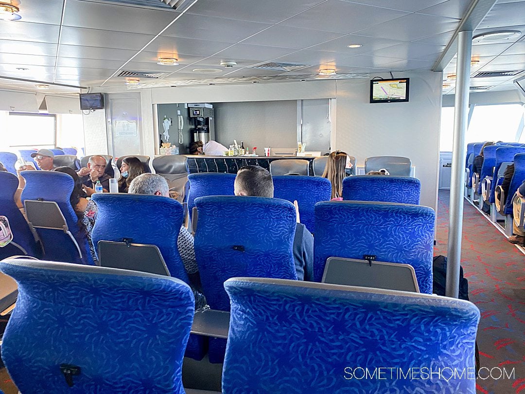 Blue seats inside the Catalina Express boat, facing a bar.