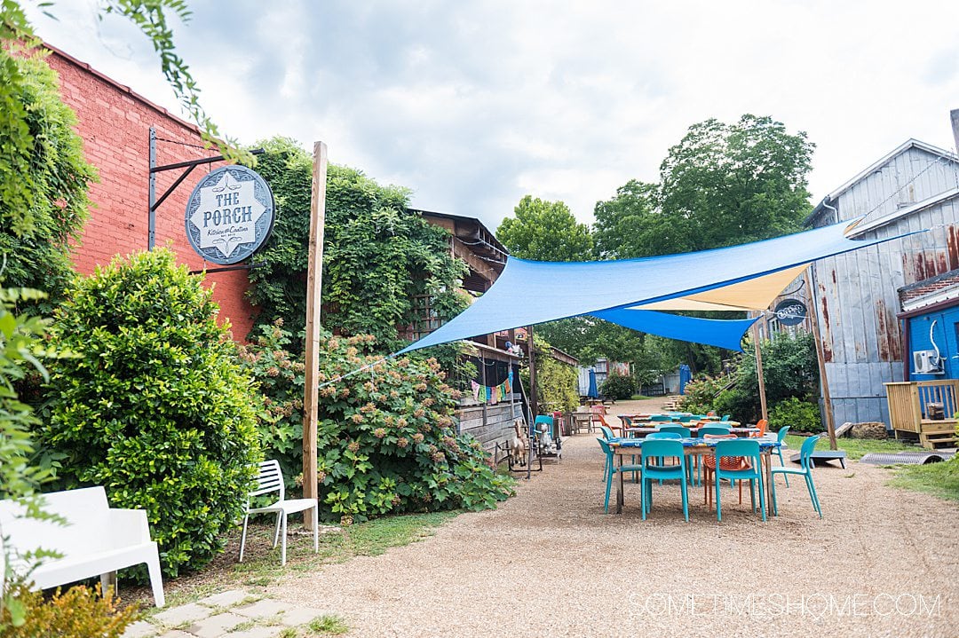 Outside seating area with colorful tables and chairs at The Porch, one of the best Winston-Salem restaurants in NC.