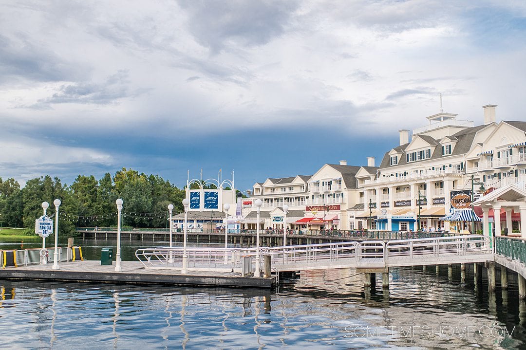 Dusk view of Disney's BoardWalk at night with the building's reflections in the water.