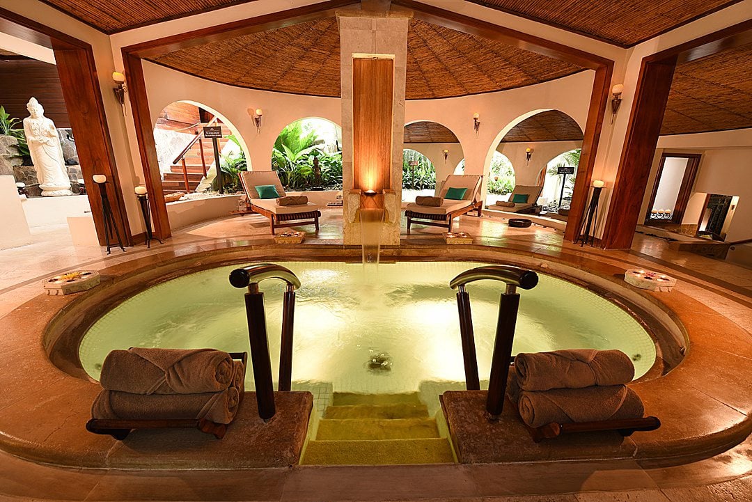 Interior of the indoor/outdoor spa pools at Tabacon Resort & Spa, with mineral hot springs.