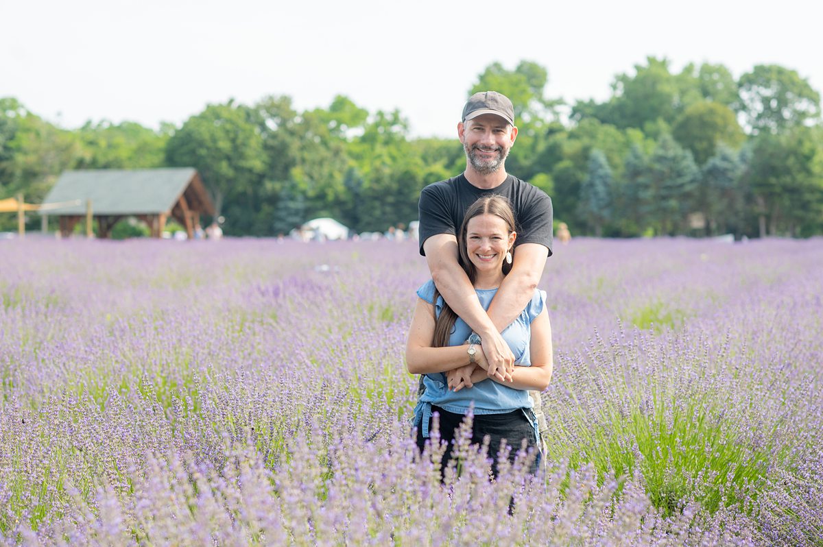 Man and woman embracing in a lavender field.
