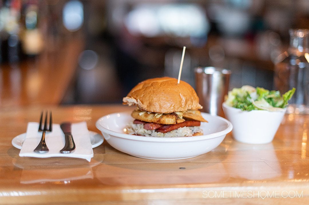 Sandwich in a wide, shallow bowl on a wooden bar in Corning, NY.