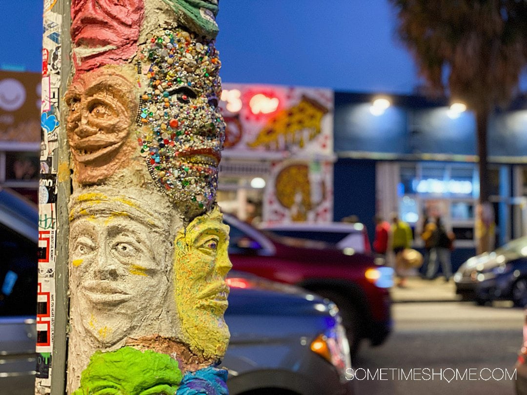 Colorful faces sculpture on the side of a telephone pole in Wynwood, Miami.