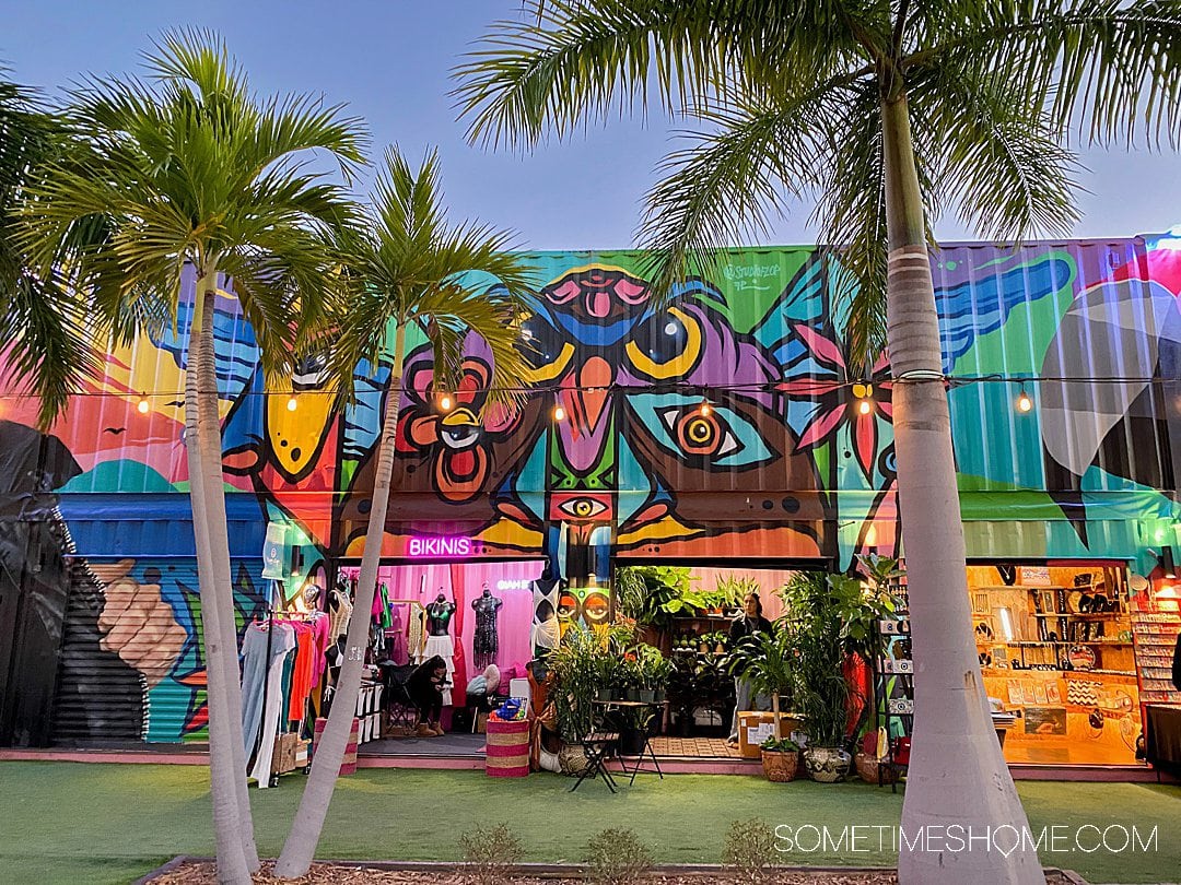 Colorful mural with an owl motif and palm trees at Wynwood Market Place.