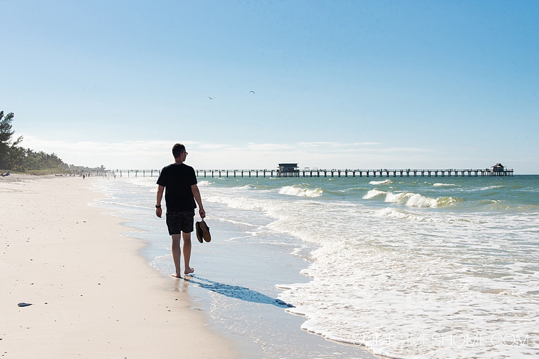 Man walking on the beach in Naples, Florida, on the Gulf Coast
