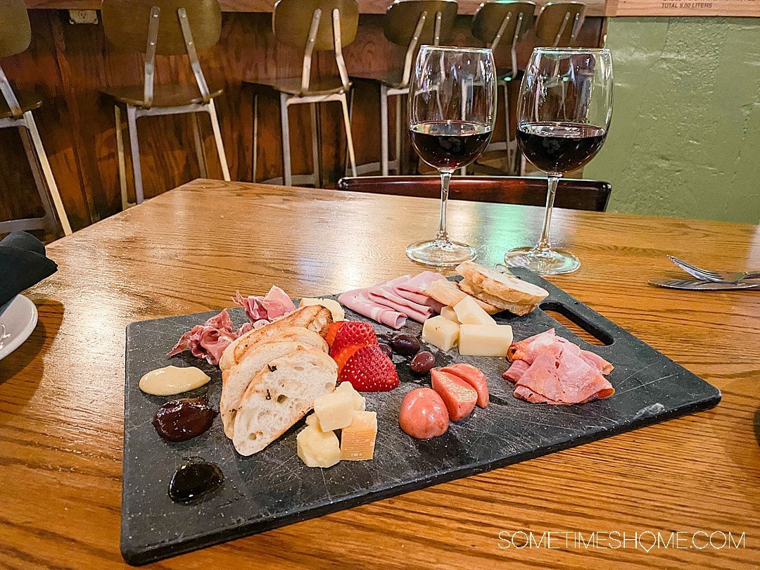 Cheese and meat charcuterie tray and two glasses of wine at 6th and Vine in Winston-Salem NC.