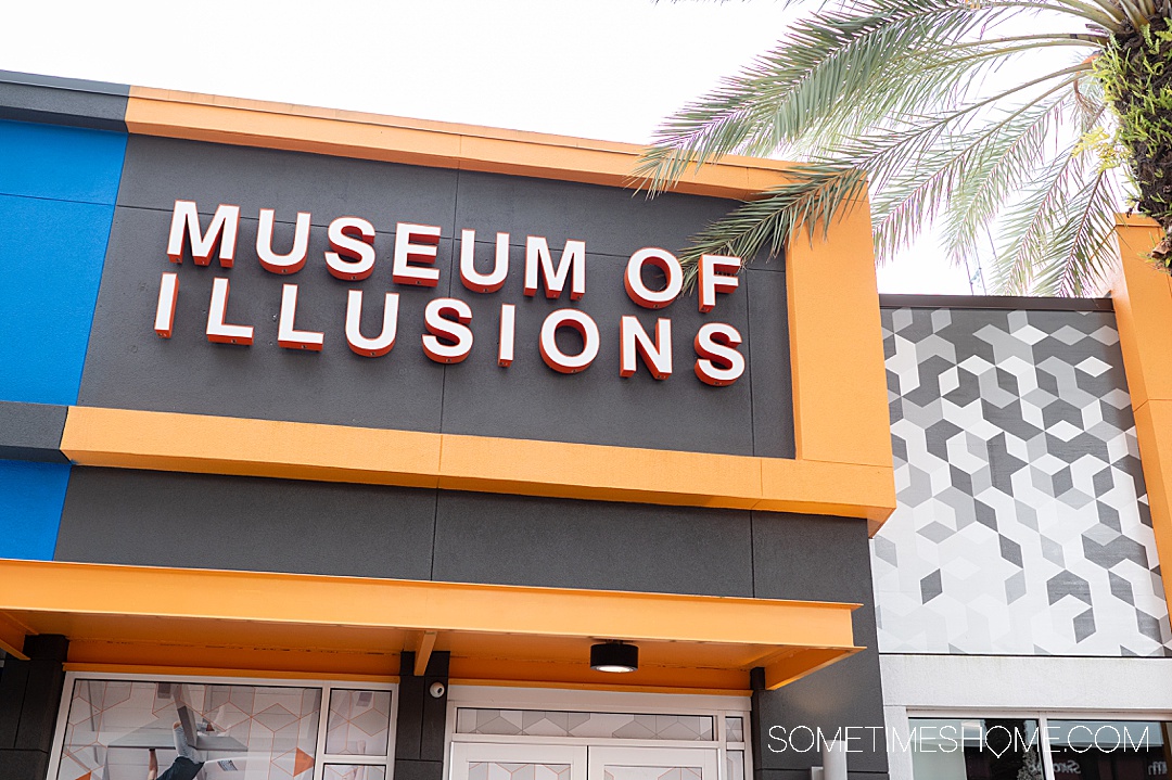 Museum of Illusions sign in orange and black in Orlando at ICON Park.