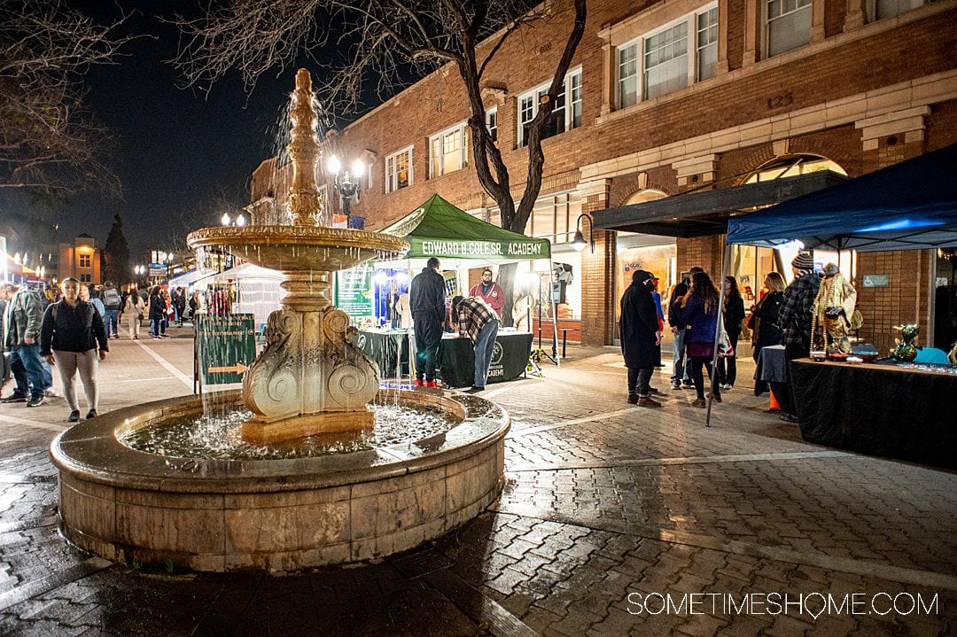 Night time on 4th Street in downtown Santa Ana, with the marble Chiarini Fountain and vendors.