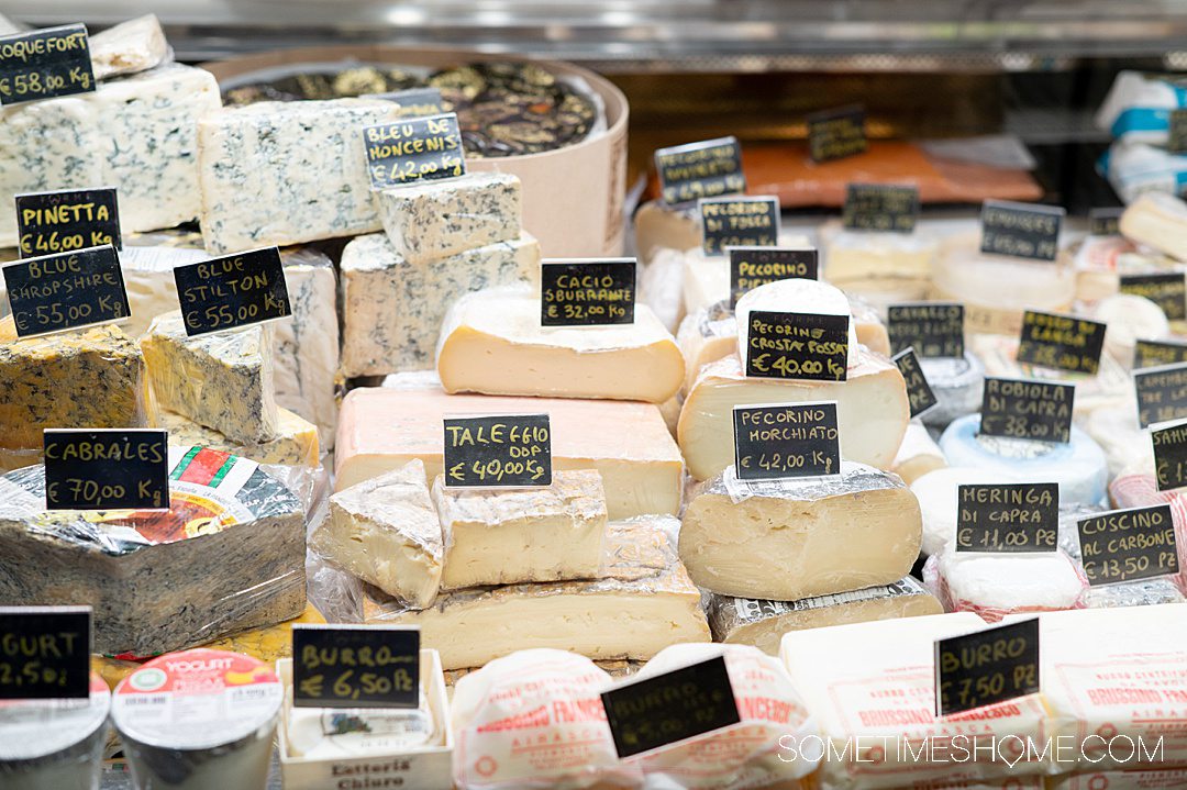 Case of Italian cheeses in a case, during a food tour in Rome.