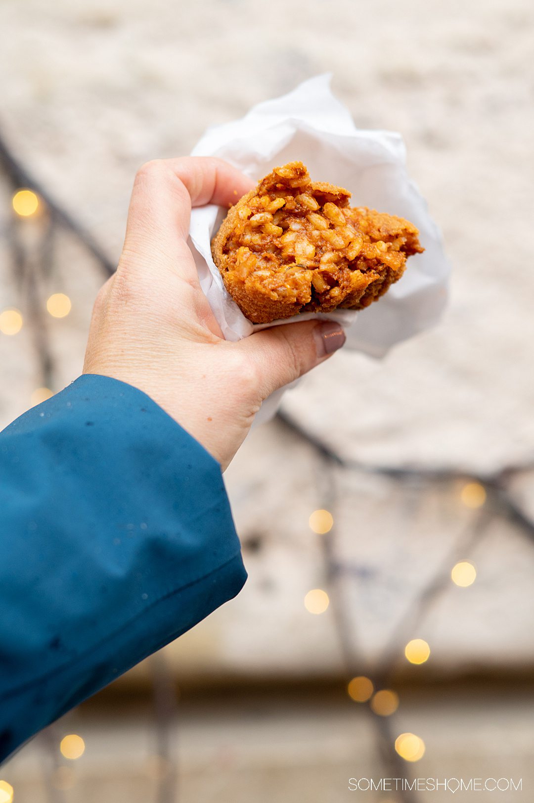 Hand holding Suppli, a Roman grab-and-go food, during a Devour food tour.