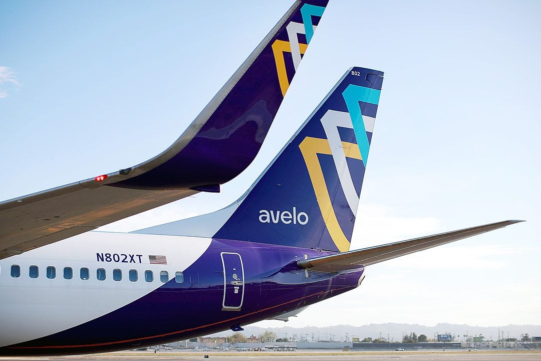 Avelo Airlines purple tail with a blue, white, and yellow graphic.