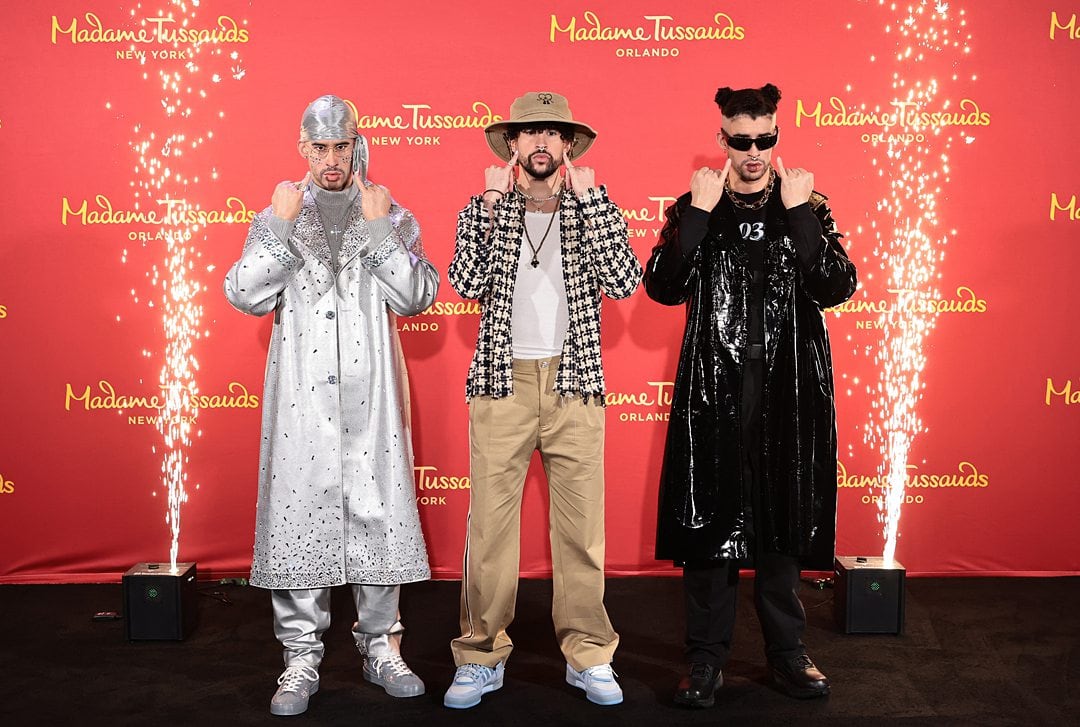 Bad Bunny in between two wax statues of himself for the Madame Tussauds Orlando launch.