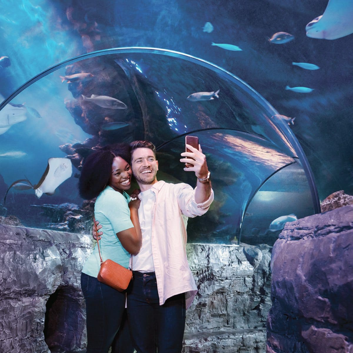 Couple taking a selfie inside the SEA LIFE Aquarium Orlando tunnel.