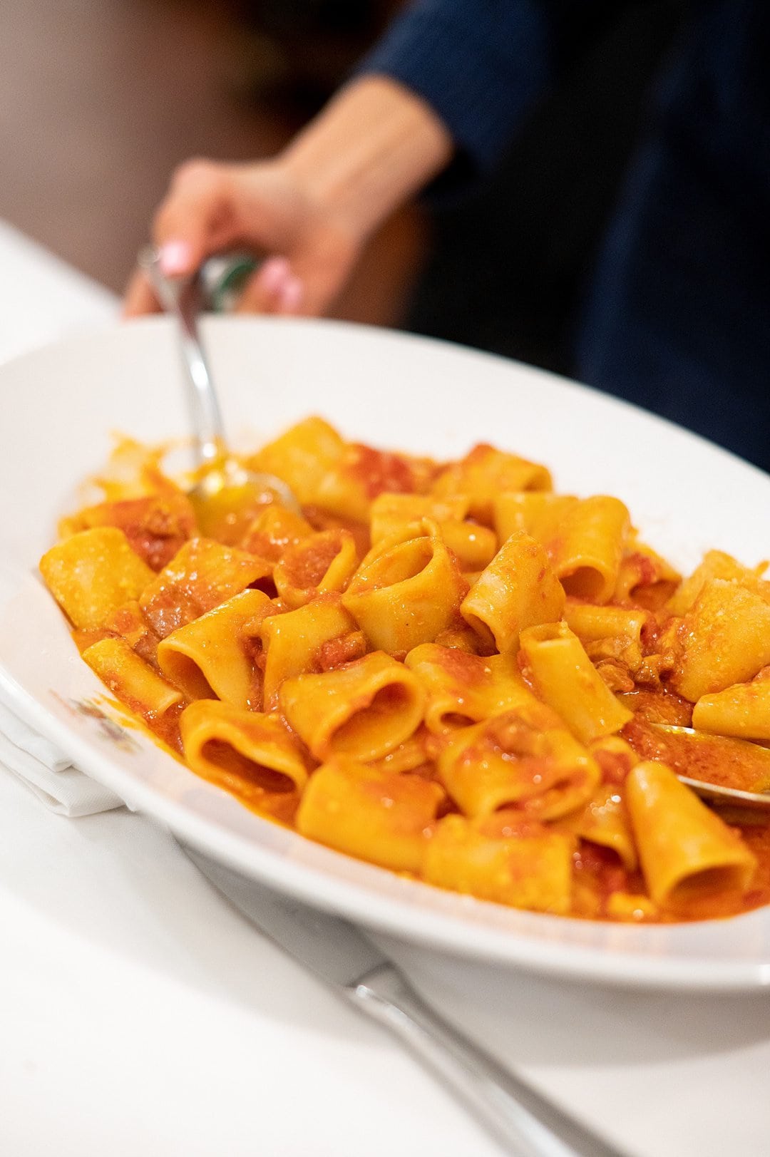 Plate of Pasta Amatriciana, a dish in Rome with a red sauce.