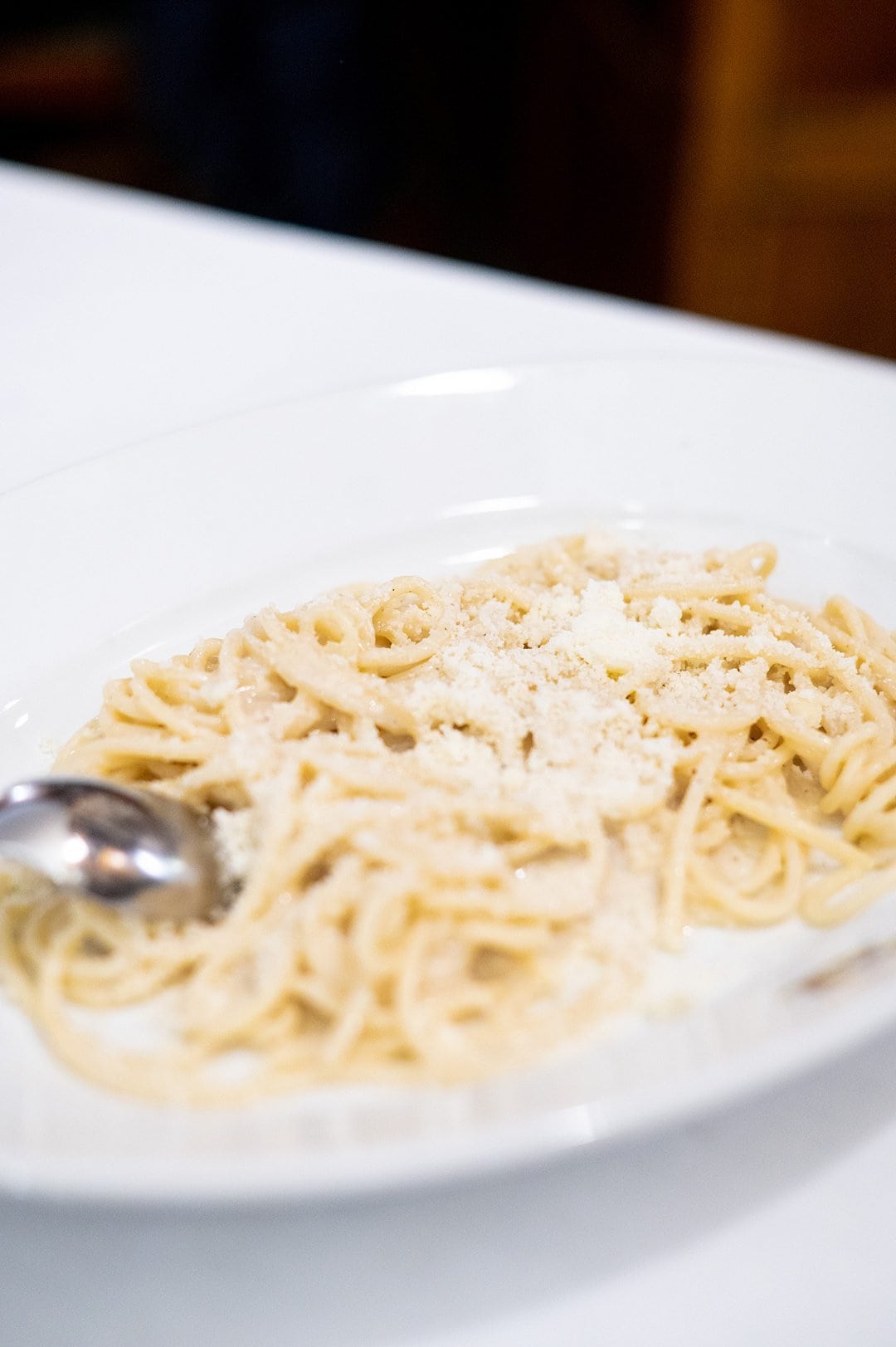 Plate of spaghetti served cacio e pepe style.