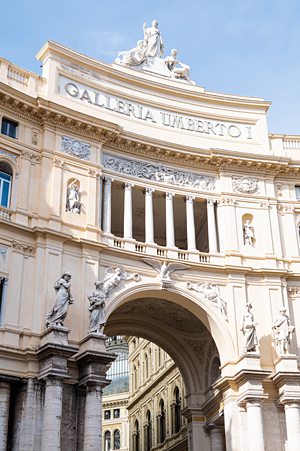 Grand galleria entrance in Naples, Italy with columns and arches.