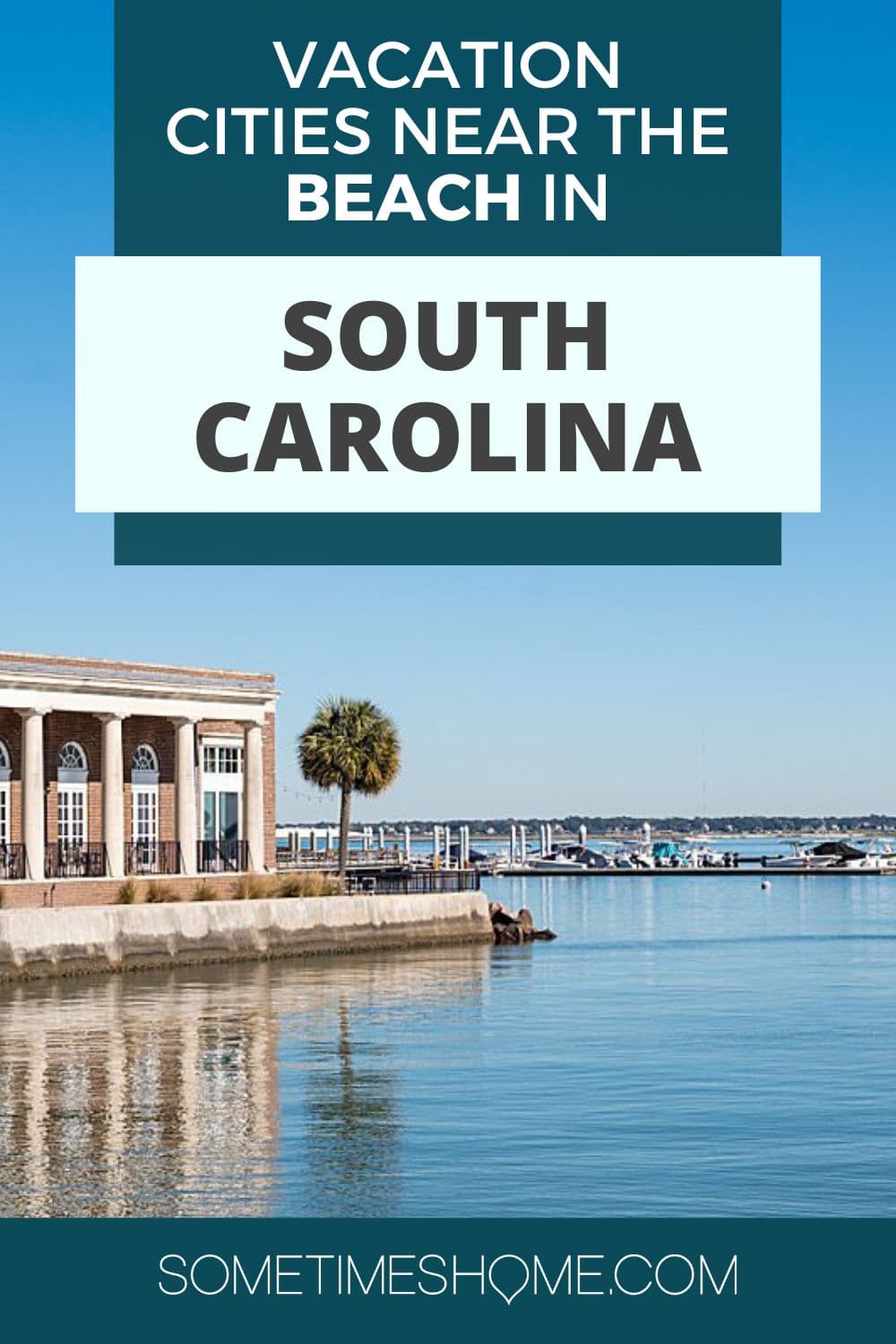 Waterfront area of downtown Charleston of a building and blue sky reflecting in the water.