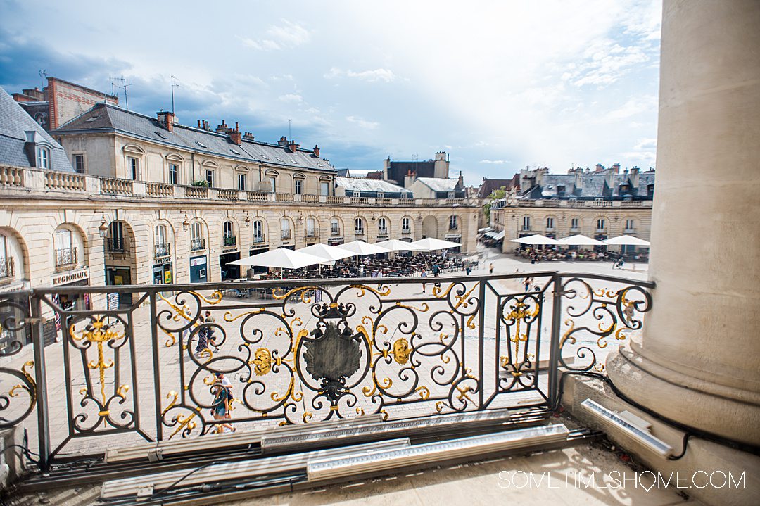 Ornate gold and black balcony railing that looks down to the palace square in Dijon, France.